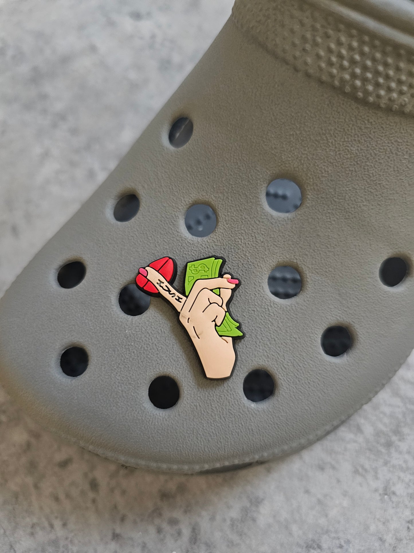 Money, finger on lips holding notes shoe charm