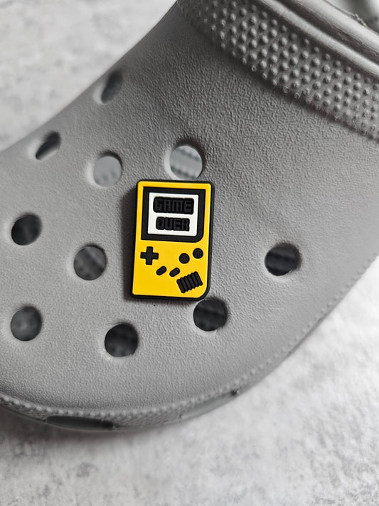 Yellow hand game console shoe charm